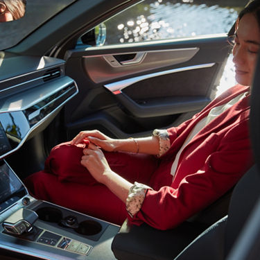 Person in red sitting inside a car.