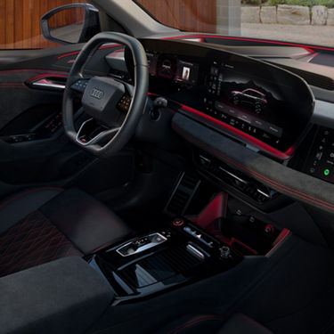 Interior of a car with digital displays, steering wheel, and center console.