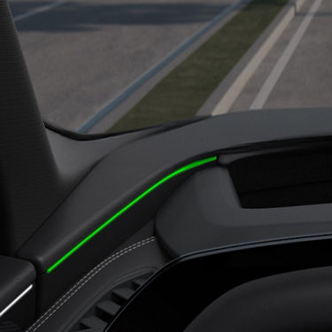 Car interior with a sleek green ambient light strip on the dashboard.