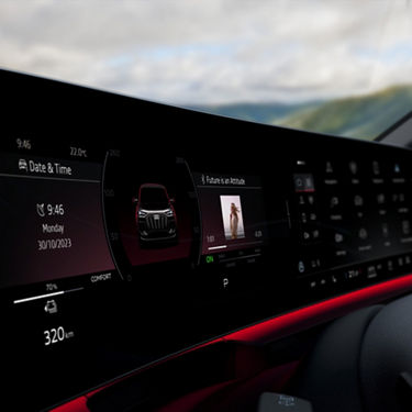 Audi car dashboard display with multimedia interface, date, time, and vehicle status indicators.