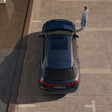  Aerial view of Audi SQ8 in parking bay with lady walking away.