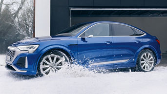 EIn blauer Audi steht in einer Schneelandschaft